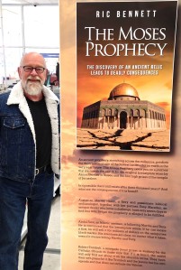 Ric Bennett with a display stand to promote his book, The Moses Prophecy